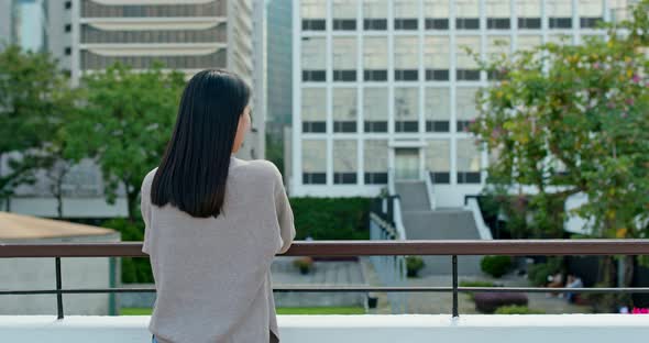 Woman look at the view with business tower background