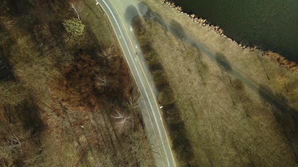 Bicycle path near the city reservoir. Aerial photography. Shot camera down.