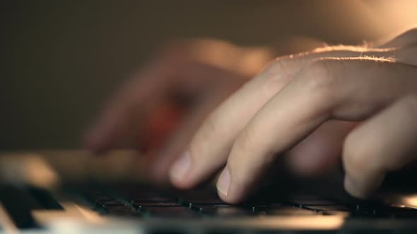 Programmer's Hands Typing Commands on Laptop Keyboard