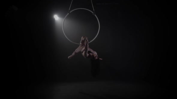 Young Girl Performs the Acrobatic Elements in the Air Ring. Slow Motion. 016