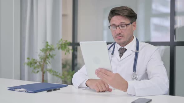 Doctor Talking on Video Call on Tablet in Clinic