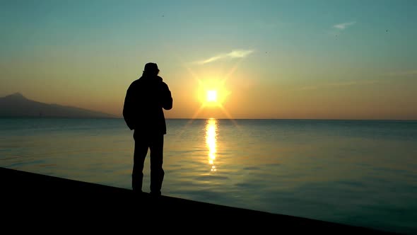 Alone Man Smoke Cigarettes Near The Seaside and Looking Sea