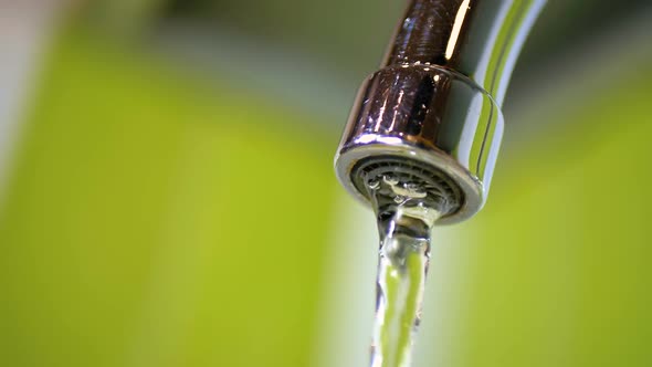 Water Running From the Tap Into a Sink. Slow Motion