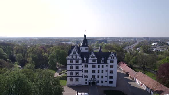 zoom out from clock tower to whole castle and surroundings in Wolfsburg