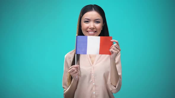 Girl Covering Face With French Flag, Learning Language, Education and Travel