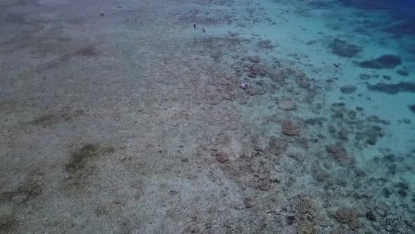 Local boat and snorkeler in waterCalm aerial view flight flyover drone footage of Gili Trawangan dr