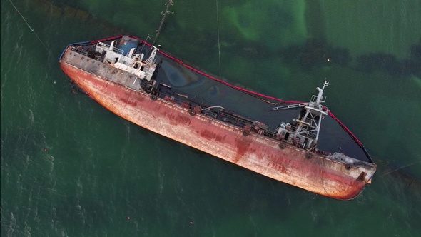 Old rusty ship sunk on the Sea on the beach.