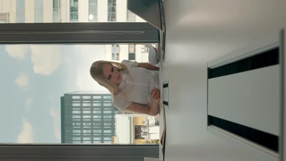 Young Businesswoman in Conference Room with Papers. Elegant Blond Woman Sitting at Long Table in