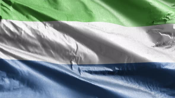 Sierra Leone flag waving on the wind. Slow motion. 20 seconds loop.