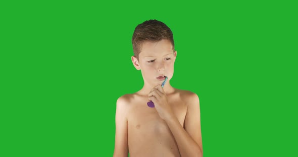 Beautiful Boy Brushing Teeth on Green Screen.