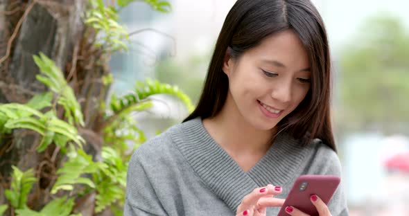 Woman use of mobile phone at outdoor