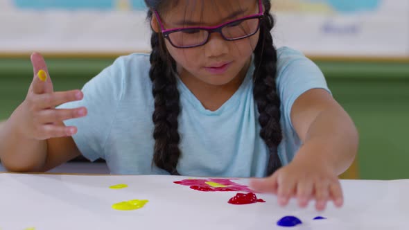 Young girl finger painting