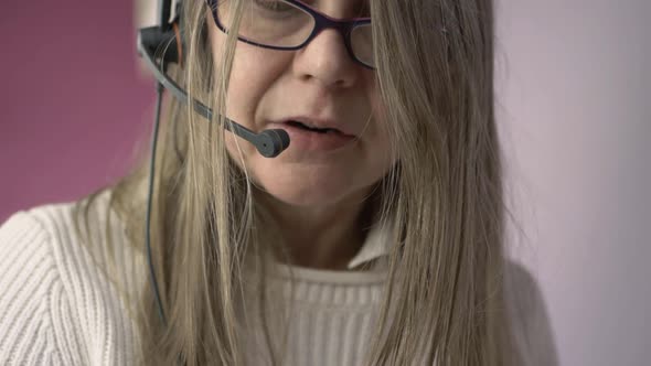 Woman wearing headset talking to customer medium shot