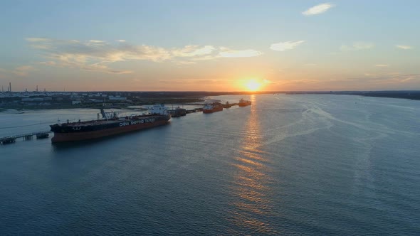 Sunset Over Southampton Docks With Ships Being Loaded With Cargo
