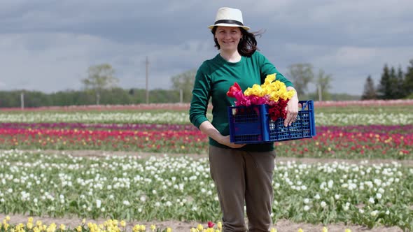 Portrait Happy Female Farmer Holding Basket Box Fresh Picked Tulips Flowers Farm