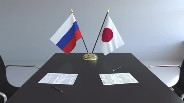 Flags of Russia and Japan on the Table