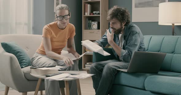 Stressed couple managing their finances at home