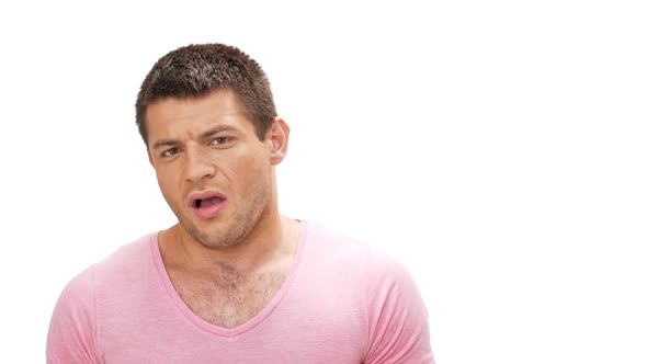 Diapleased Young Man Looking at Camera Over White Background Slow Motion