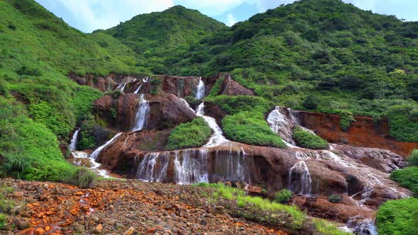 Golden waterfall. Nature landscape of Jinguashi in Ruifang area, Taipei, Taiwan.