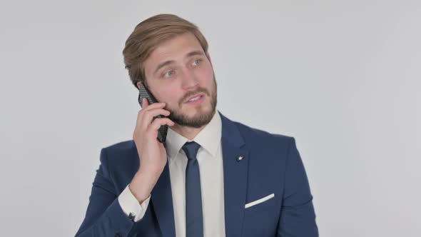 Young Businessman Talking Angry on Phone on White Background