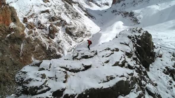 Hiker Man On Snowy Mountain