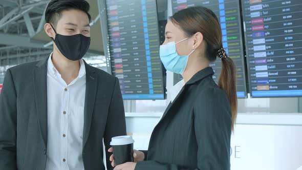 two asian businessman and businesswoman with face mask protection