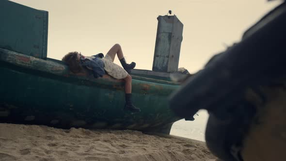 Carefree Woman Lying Old Boat on Beach