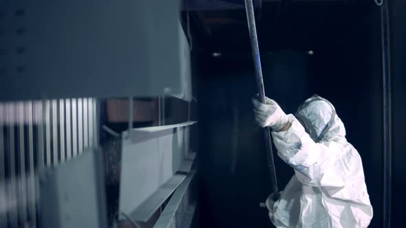 Female Worker in Safety Wear is Transporting Metal Plates Into the Industrial Oven