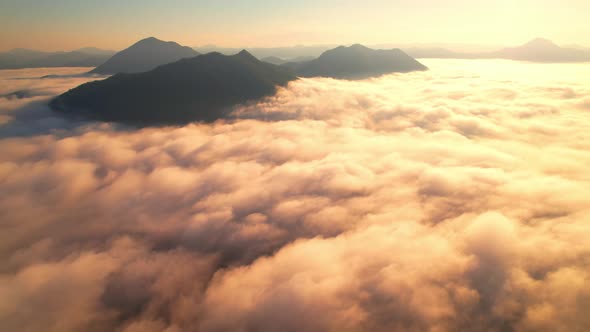 4K Aerial video Beautiful sunrise above dense clouds and fog in the morning