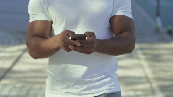 Cropped Shot of African American Using Smartphone Outdoor