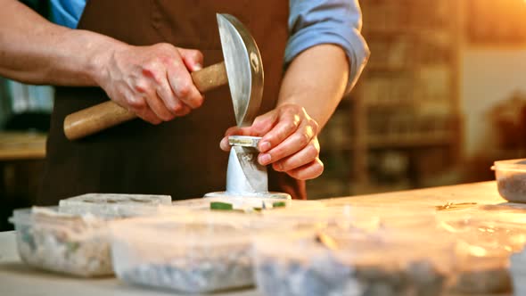 Working man with a hammer in creative workshop