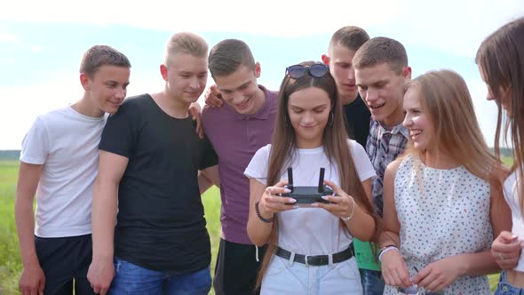 Cheerful Friends Control the Drone Using the Remote Control