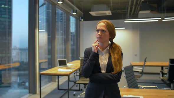 Young Buusiness Lady Standing Inside of the Office and Thought and Dreaming