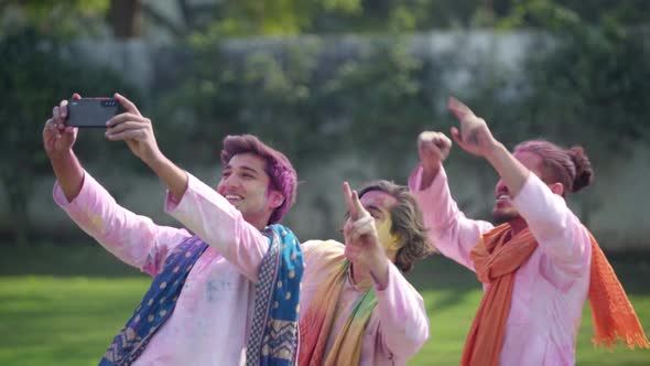 Indian boys taking selfies on Holi