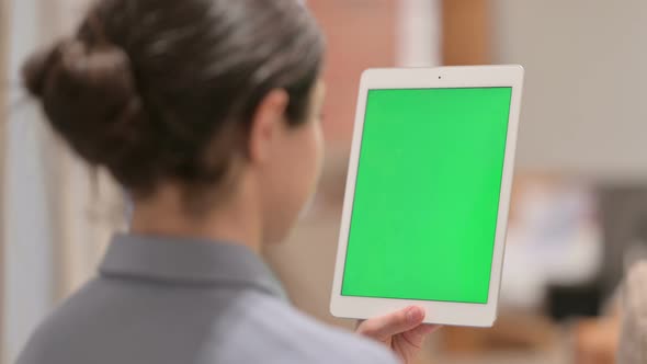 Rear View of Young Indian Woman using Tablet with Chroma Screen