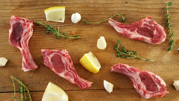 Raw meat chops, rosemary and lemon marinated with salt