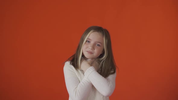 A Little Girl Has a Sore Throat Against an Orange Background