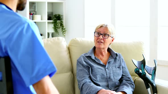 Male Nurse and Senior Woman Having a Conversation alt