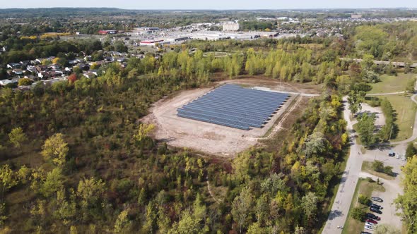 Wide aerial view of solar panels on the outskirts of the city