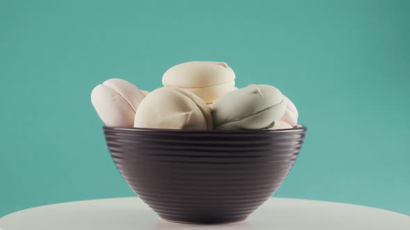 Close-up, Coloured Marshmallows in Plate on Rotating Table, Turquoise Background