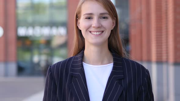 Portrait of Smiling Businesswoman Looking at Camera