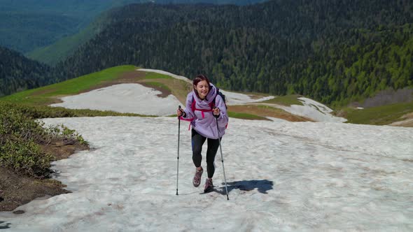 Young Female Traveller is Walking at Top of Mount and Smiling Hiking and Exploring