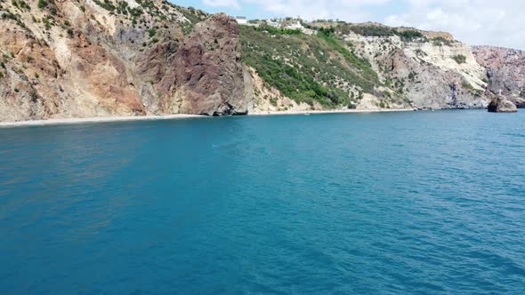 Aerial View From Above on Azure Sea and Volcanic Rocky Shores