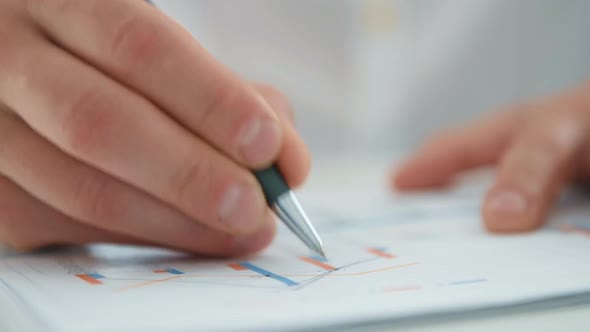 Close Up Of Businessman Hands Analyzing Business Report