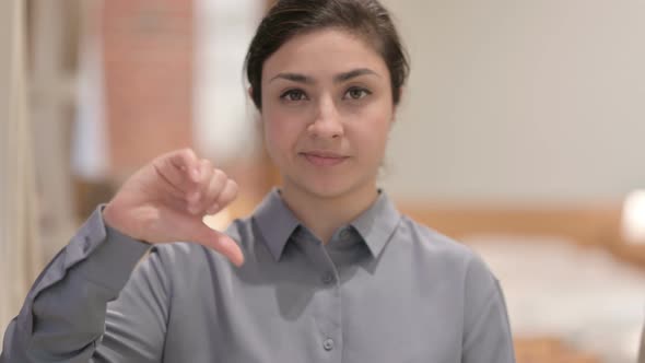 Portrait of Young Indian Woman showing Thumbs Down