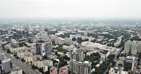 Flight Over the City of Almaty in the Smog.