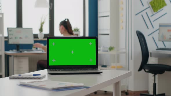 Close Up of Empty Desk with Green Screen on Laptop