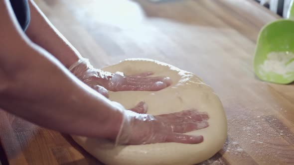 The Baker Is Rocking the Donut Pastry on the Table