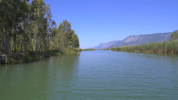 A River Surrounded By Reeds On A Flat Plain