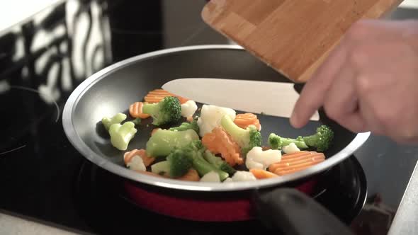 Cooking Vegetables On Frying Pan At Home Kitchen Closeup